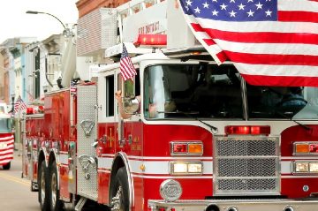 Fire Trucks with American Flags at Small Town Parade